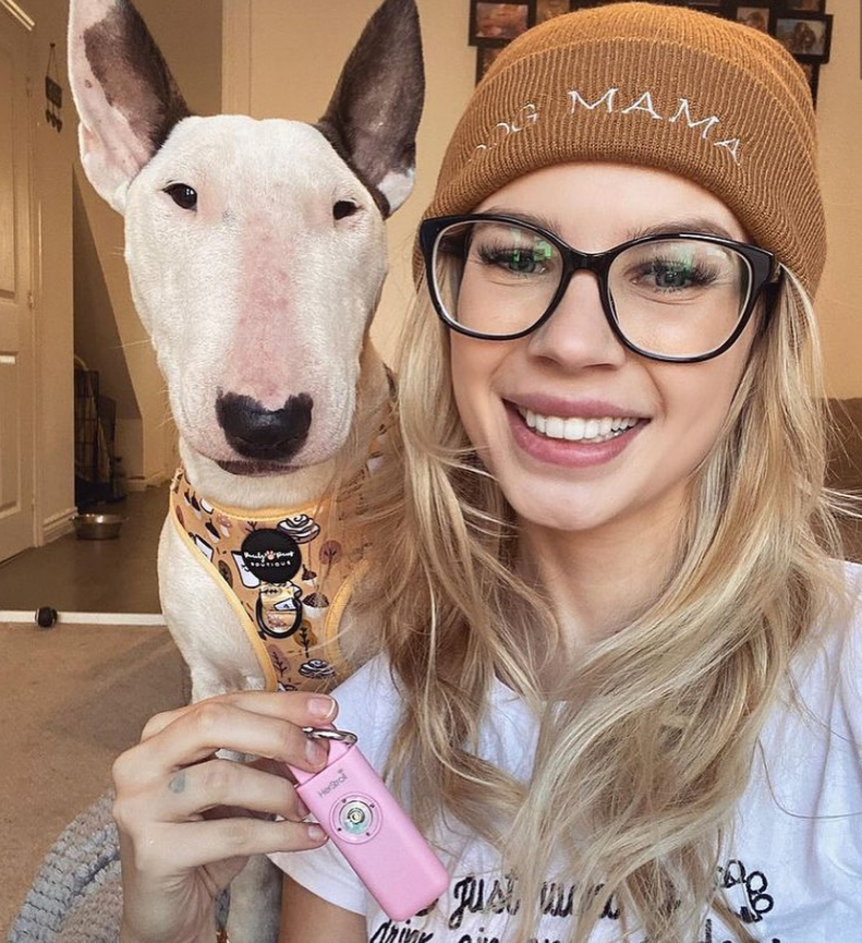 Woman with a dog holding HerStroll